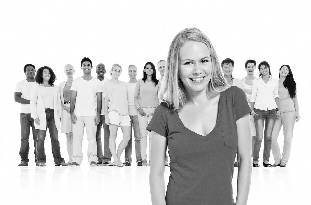 Young adult woman standing out from crowd