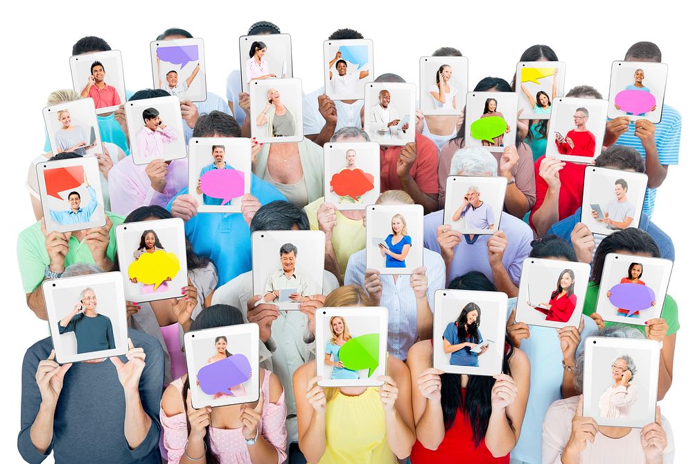 Multi-ethnic group of people holding tablets in front of the faces.