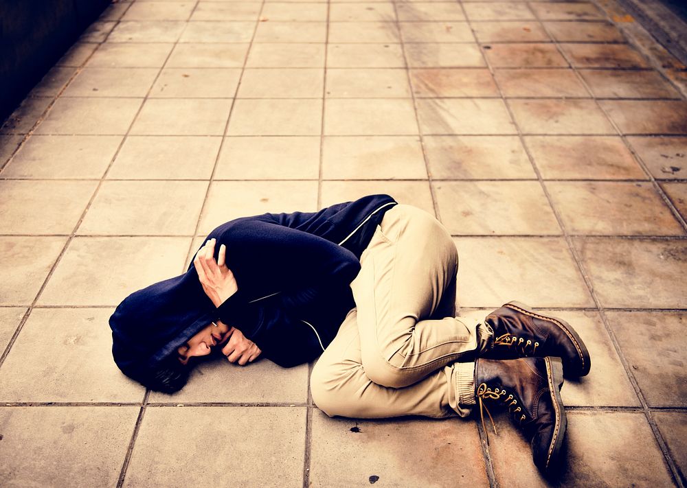 Young Asian Male Lying on the Street Depression