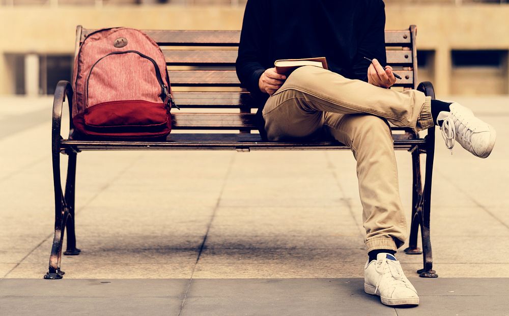 Guy sitting on a bench alone