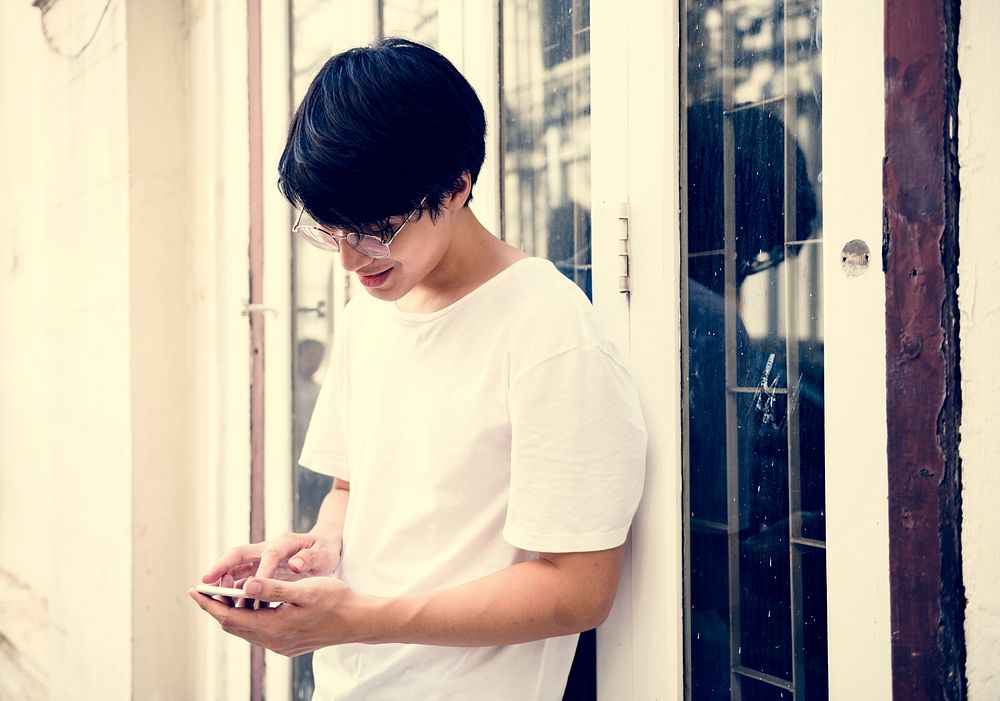 Asian Guy Standing Playing Phone