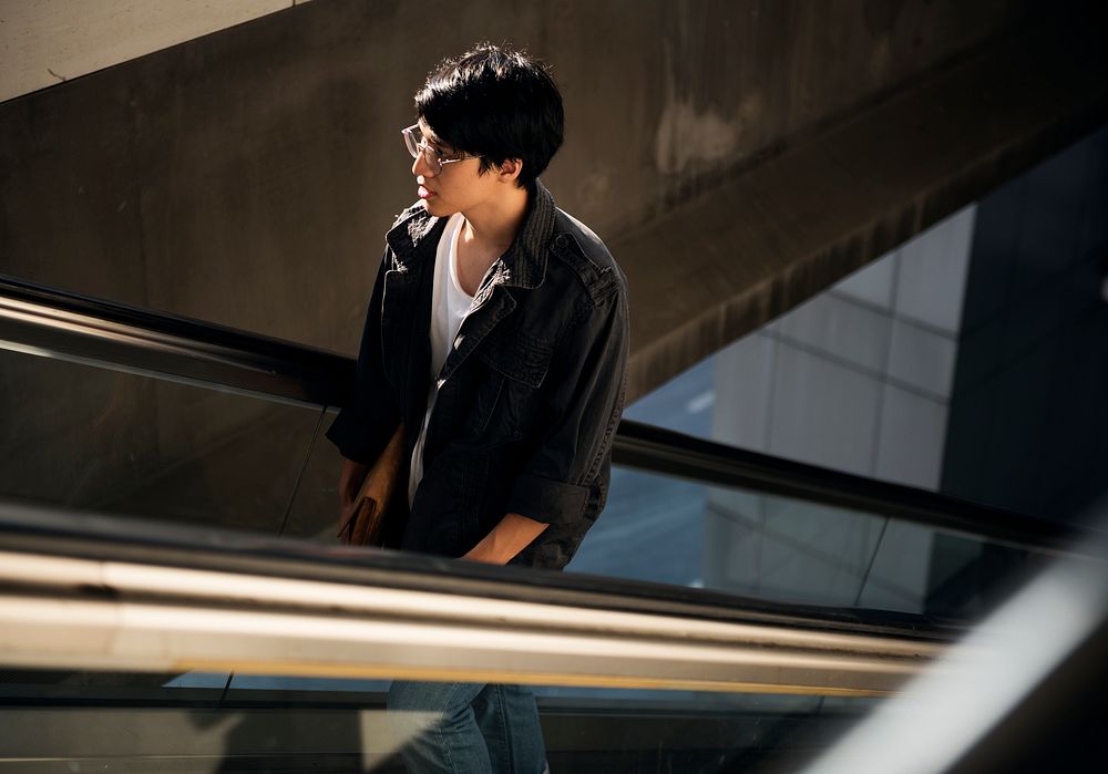 Handsome asian guy on the escalator