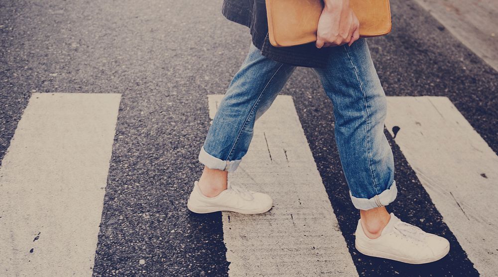 Young man wallking crosswalk commuter lifestyle