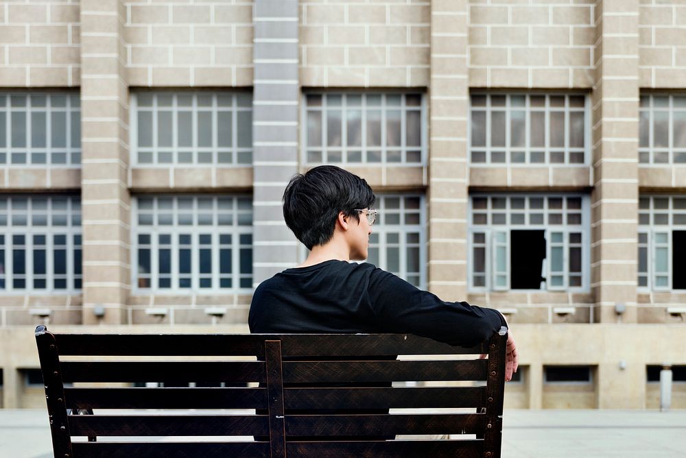 Guy sitting on a bench alone