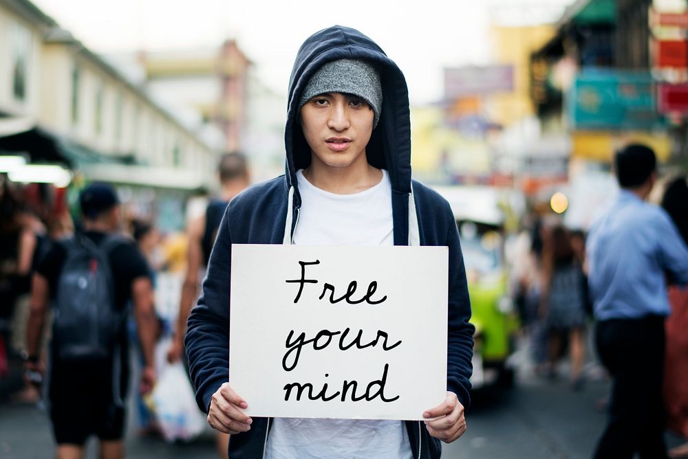 Young asian guy with a Free Your Mind placard