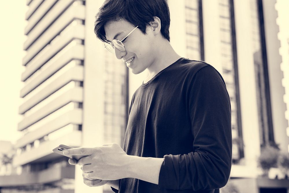 Asian man using mobile phone connection technology