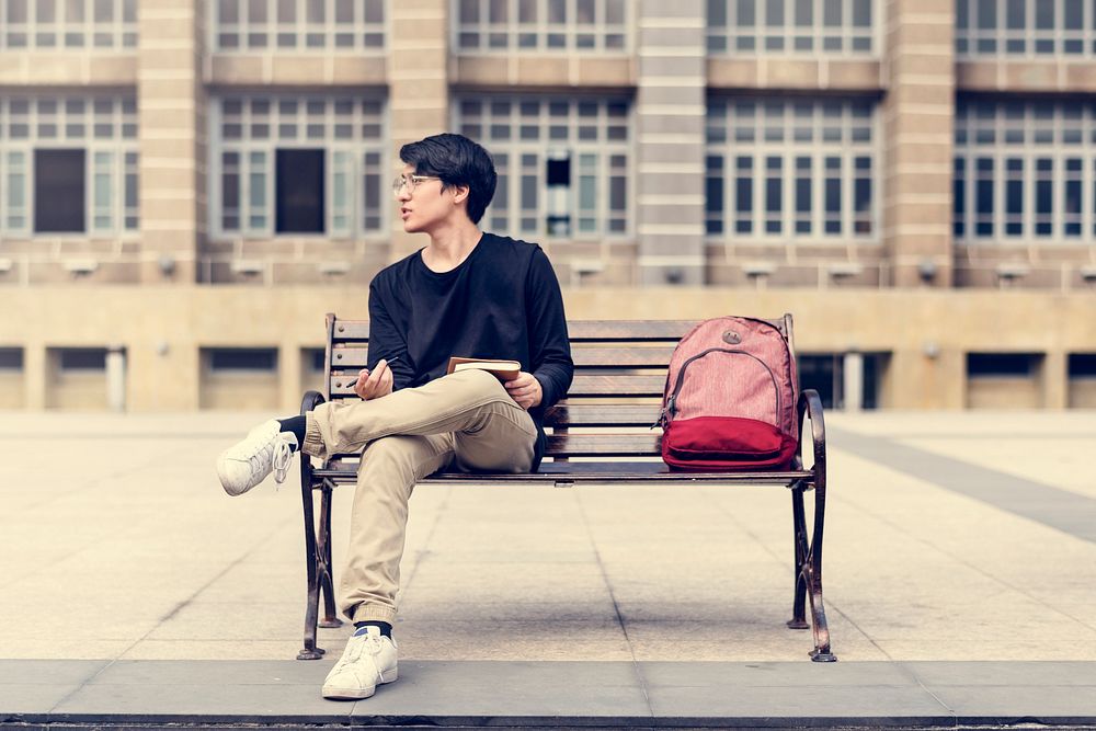 Guy sitting on a bench alone