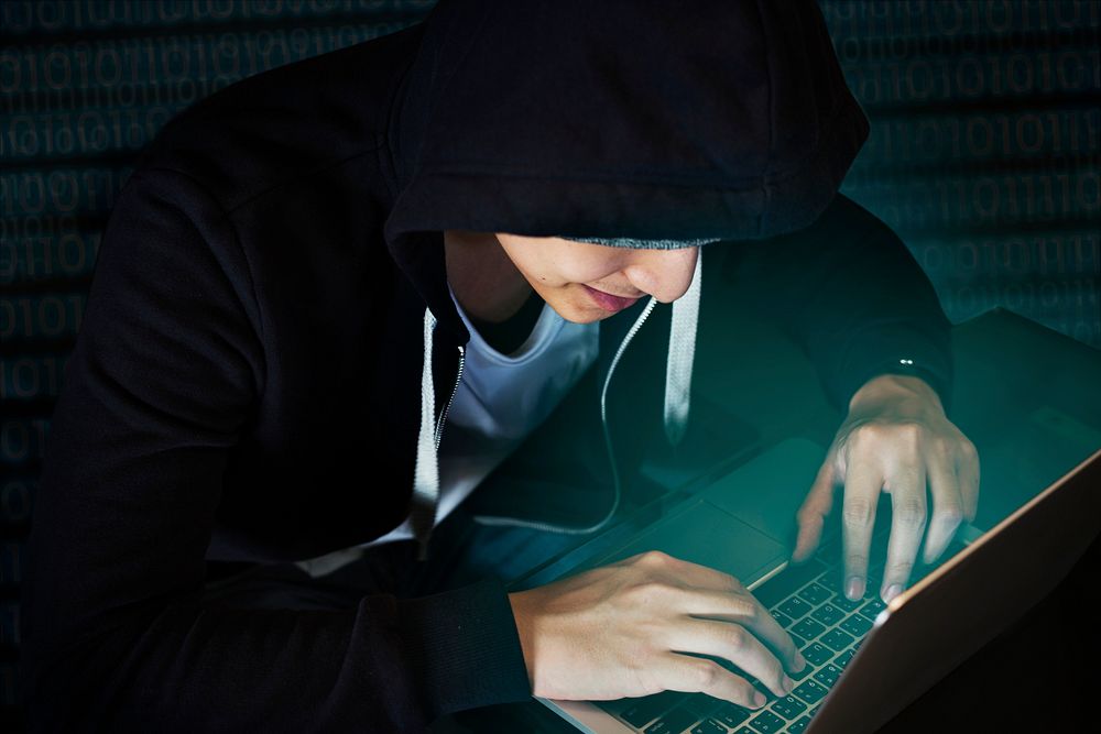 Young guy in a hoodie using laptop