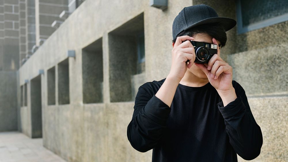 Young guy taking photos outdoors