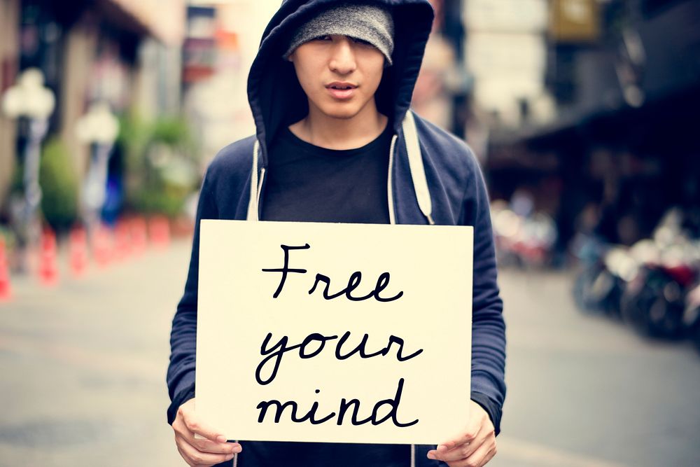 Asian Guy Holding Placard Free Your Mind Motivation