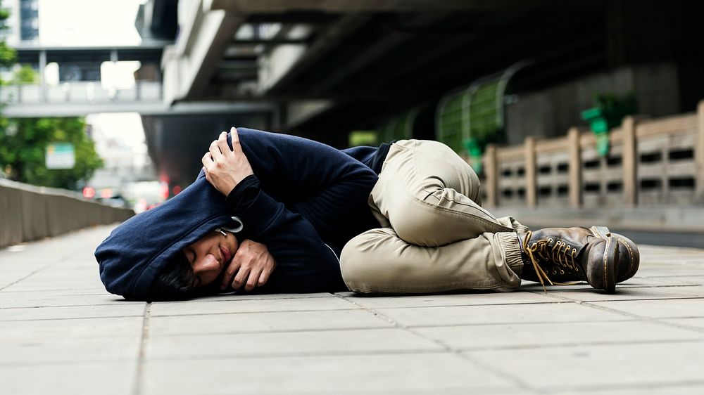 Young man homeless sleep on the street