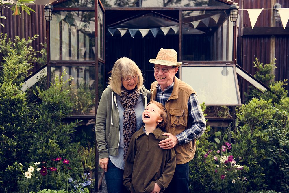 Senior Couple with Little Boy at Home Backyard