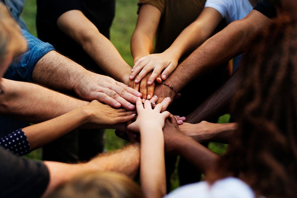 Group of people with their hands together 