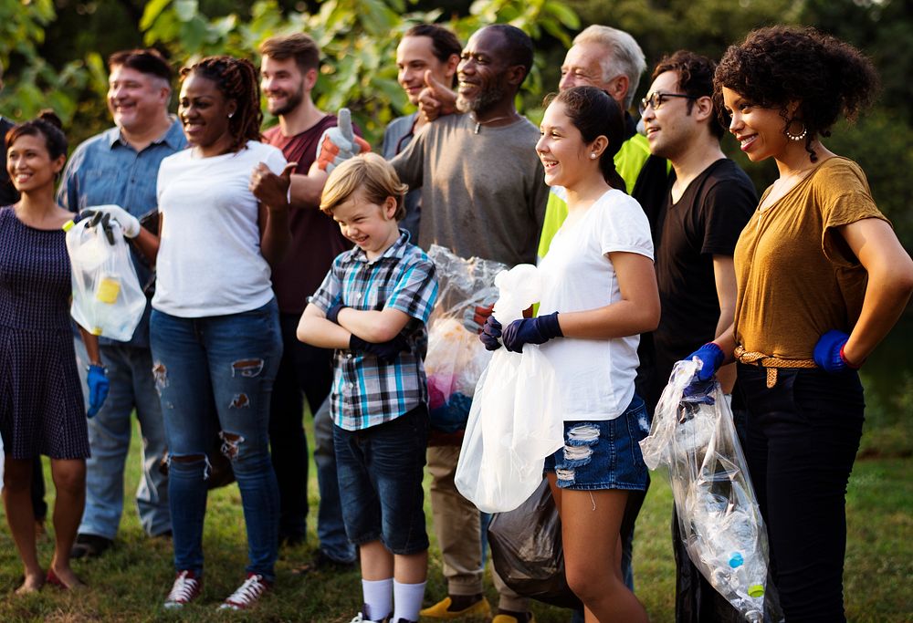 Diverse Group of People Pick Up Trash in The Park Volunteer Community Service