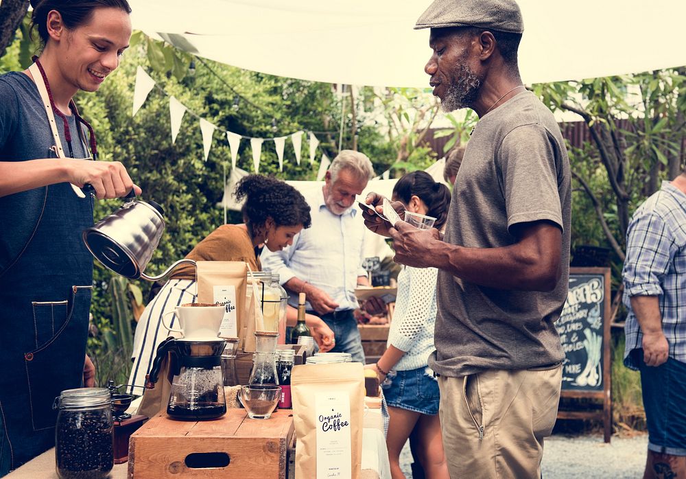 Man Selling Coffee Fresh Brew to People at Market
