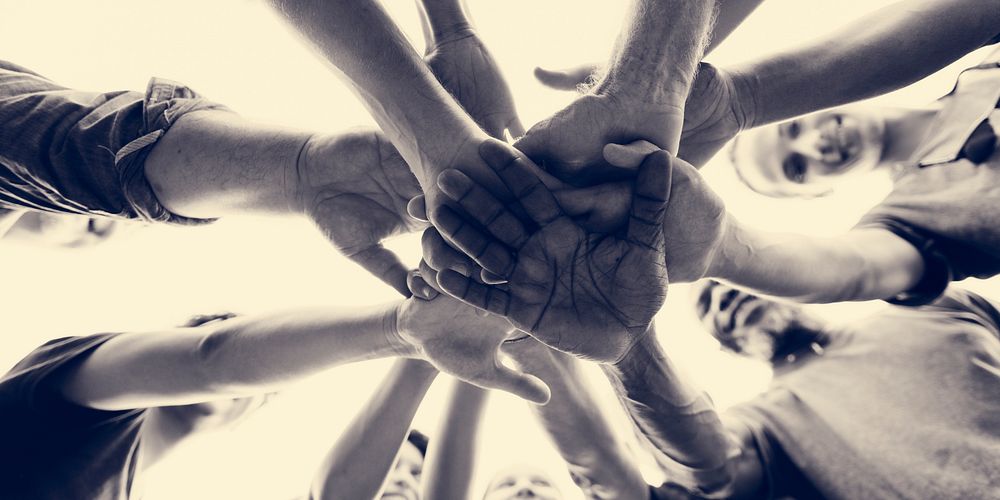 Diverse Group of People Hands Together Partnership Teamwork