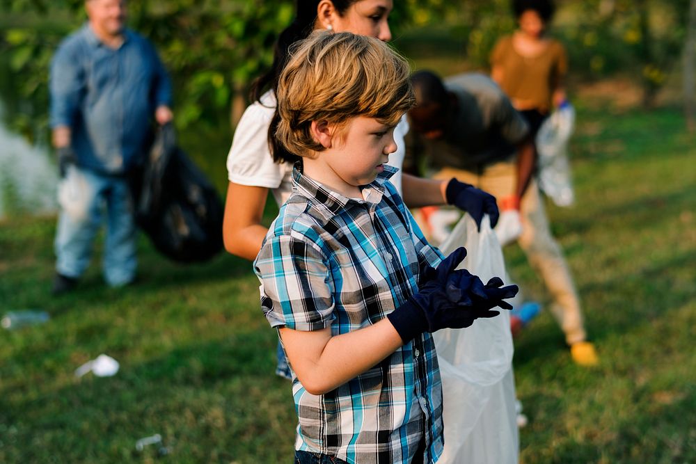 Little Boys Picking Up Plastic Bottle in The Park Volunteer Community Service