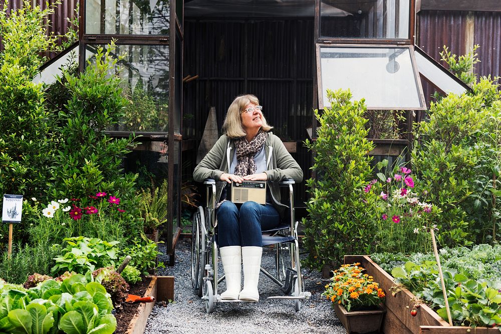 Senior adult woman on wheelchair in the garden