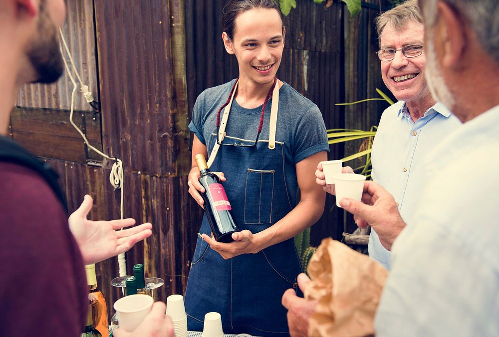 Man Offering Red Wine to Customer