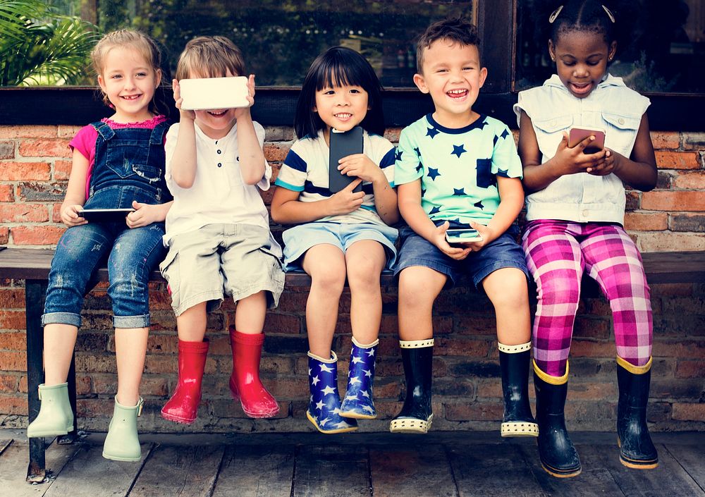 Group of Diverse Kids Using Mobile Phone Device Together