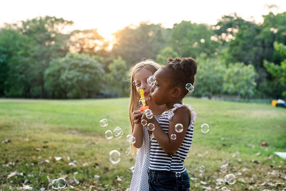 Kid with bubbles in a park