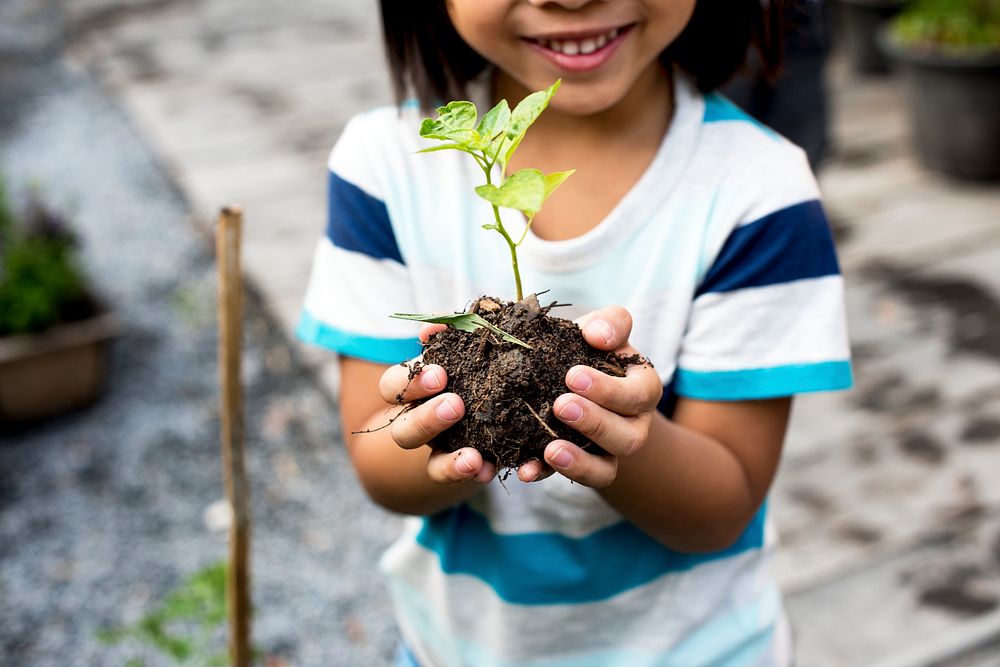 Child is holding plants
