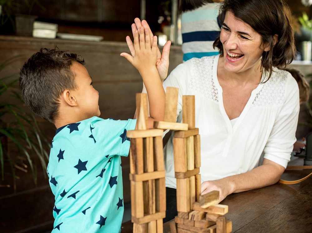 Little Boy Playing Wooden Block Toy with Teacher