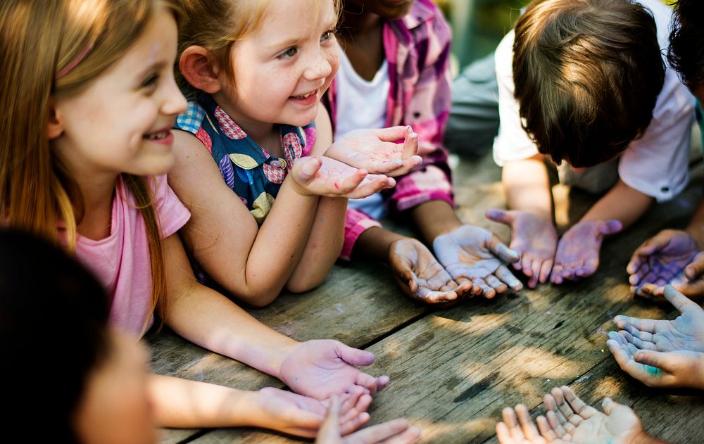 Little children fun having fun with dirt on their hands