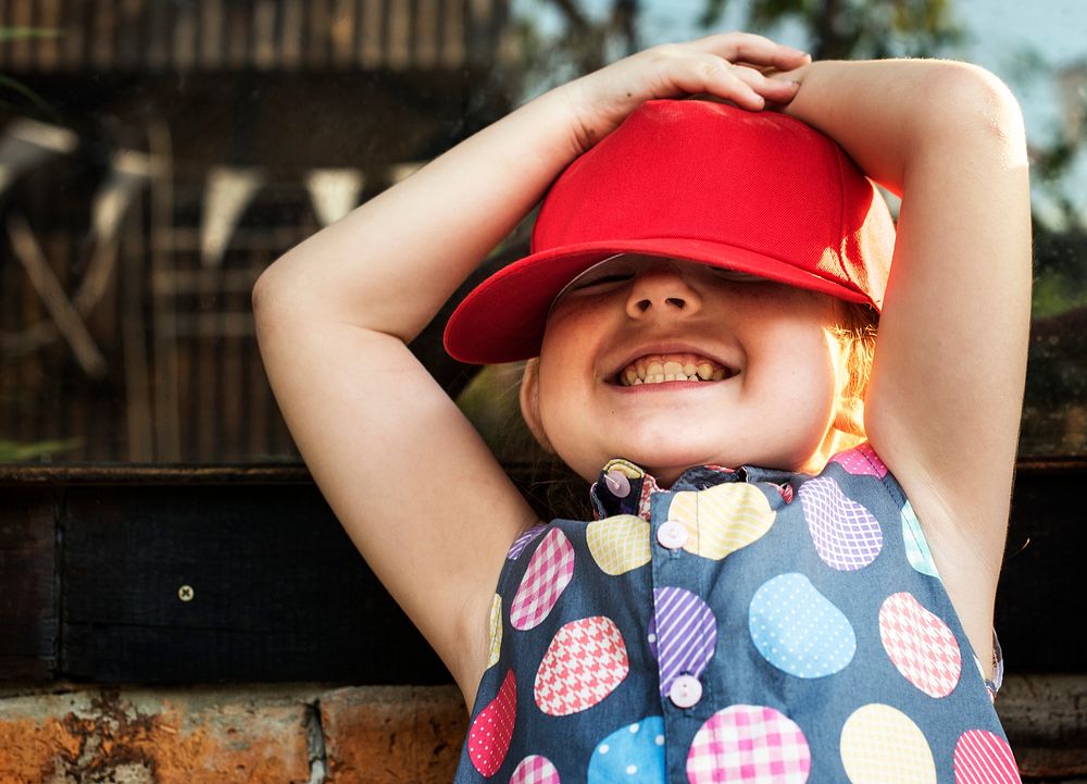 Girl is smiling with red cap