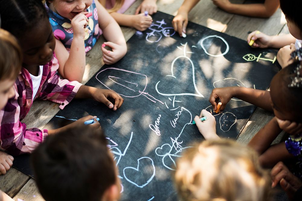 Group of children drawing on blackboard