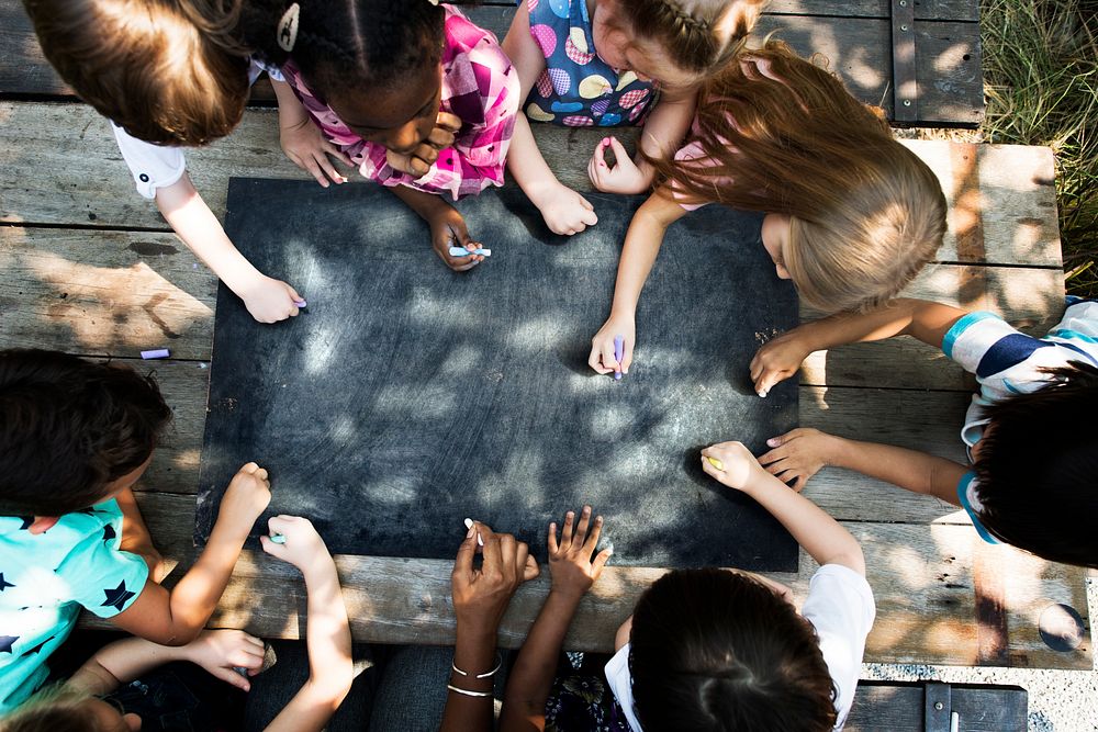 Group of Diverse Kids Drawing on Chalkboard Together