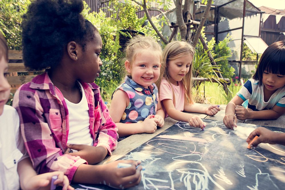 Group of Diverse Kids Drawing on Chalkboard Together