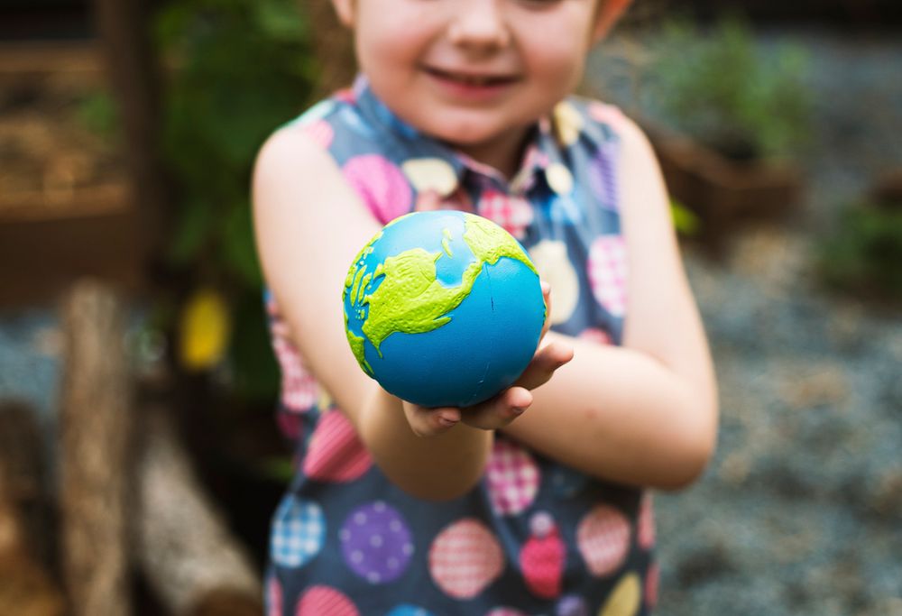 Little girl is holding a planet ball