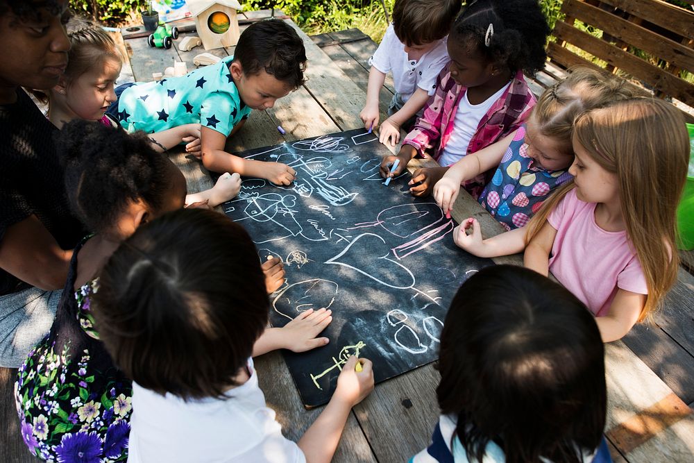 Group of kindergarten kids friends drawing art class outdoors