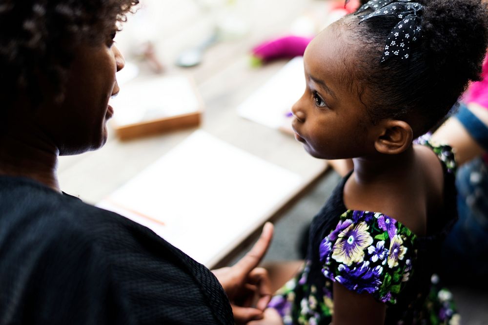 African descent girl is listening to her teacher