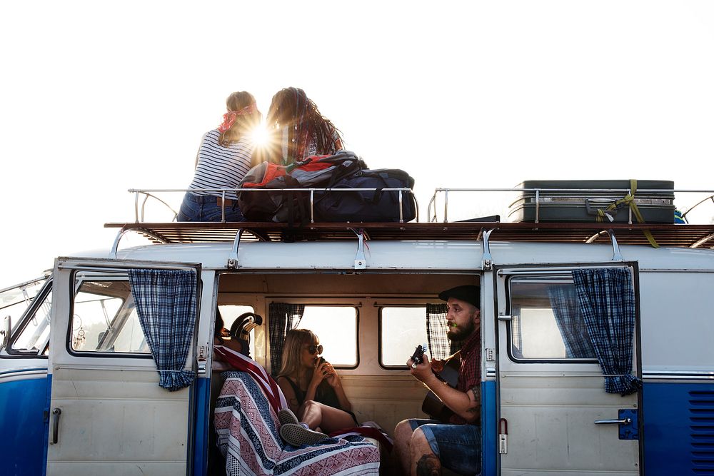 People Sitting on The Roof and inside of The Van on Road Trip Break