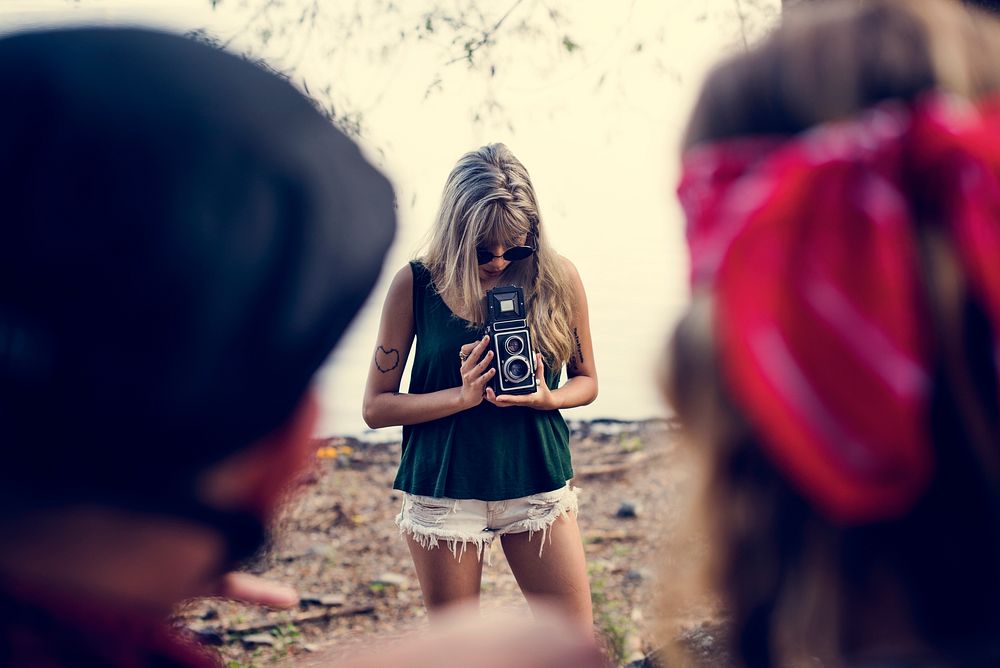 Woman Taking Friends Photo by Retro Camera on Road Trip