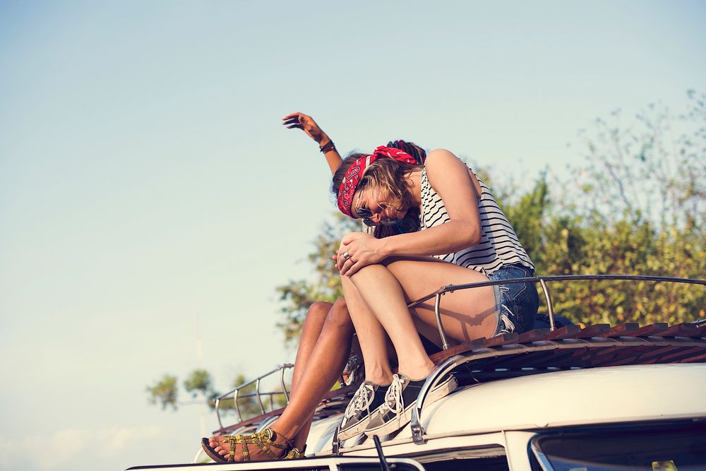 Hipster People Sitting on The Roof of The Van Road Trip Travel