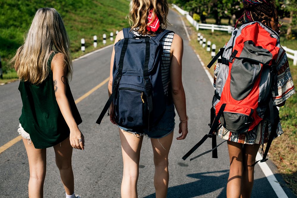 Diverse Backpacker Women Walking along The Street Side