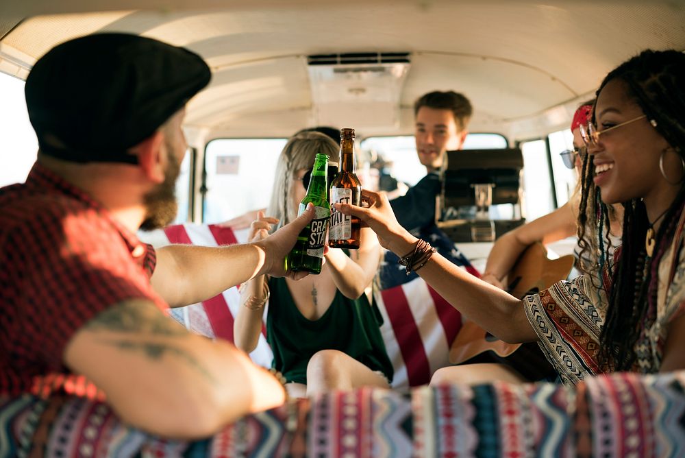 Group of Diverse Friends Drinking Beers Alcohol Together on Road Trip