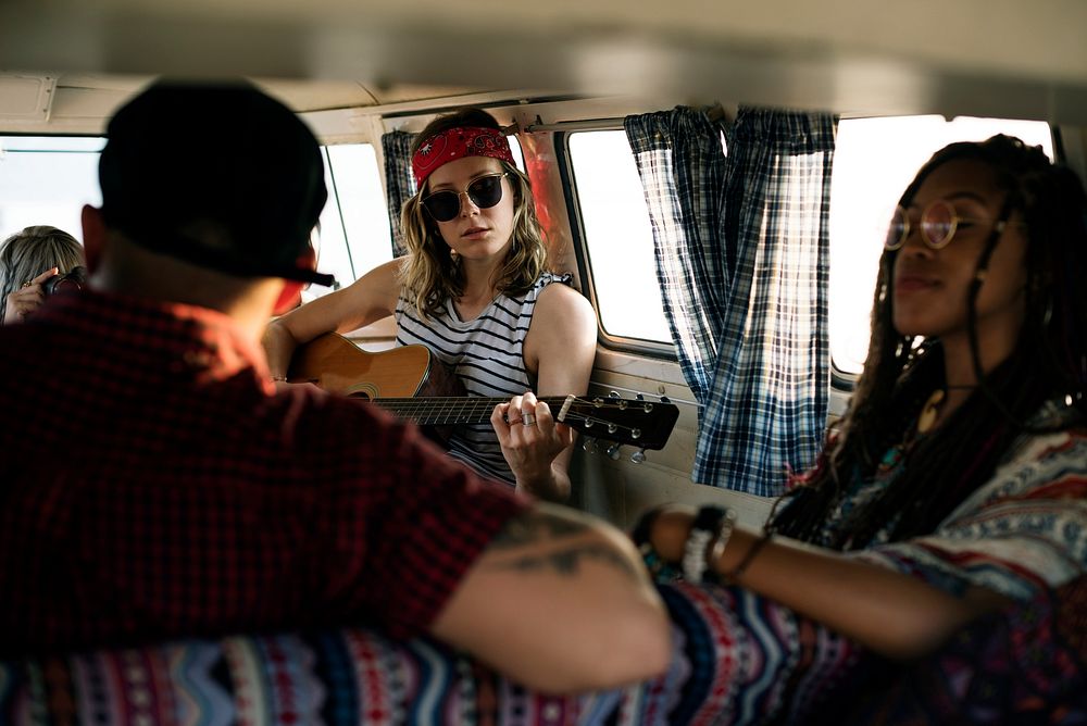 Woman Playing Guitar on Road Trip with Friends Together