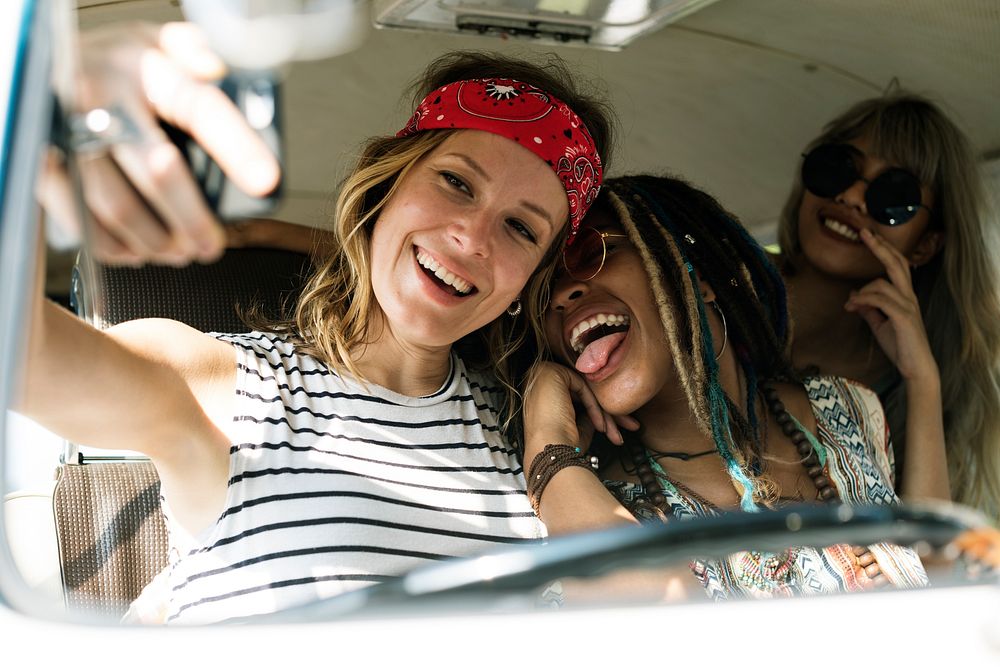 Girl friends taking a selfie on a road trip
