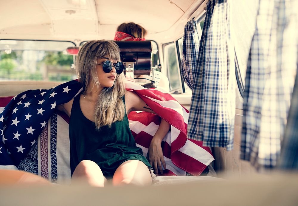 Woman Sitting in a Van Covered with American Flag