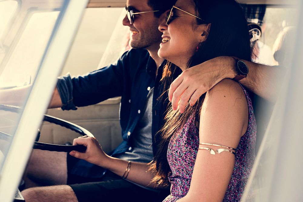 Couple Driving a Car Traveling on Road Trip Together