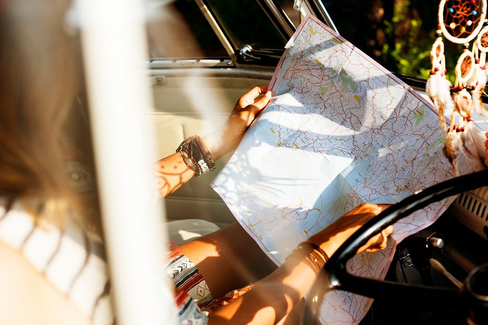 People Checking The Map for Direction on Road Trip