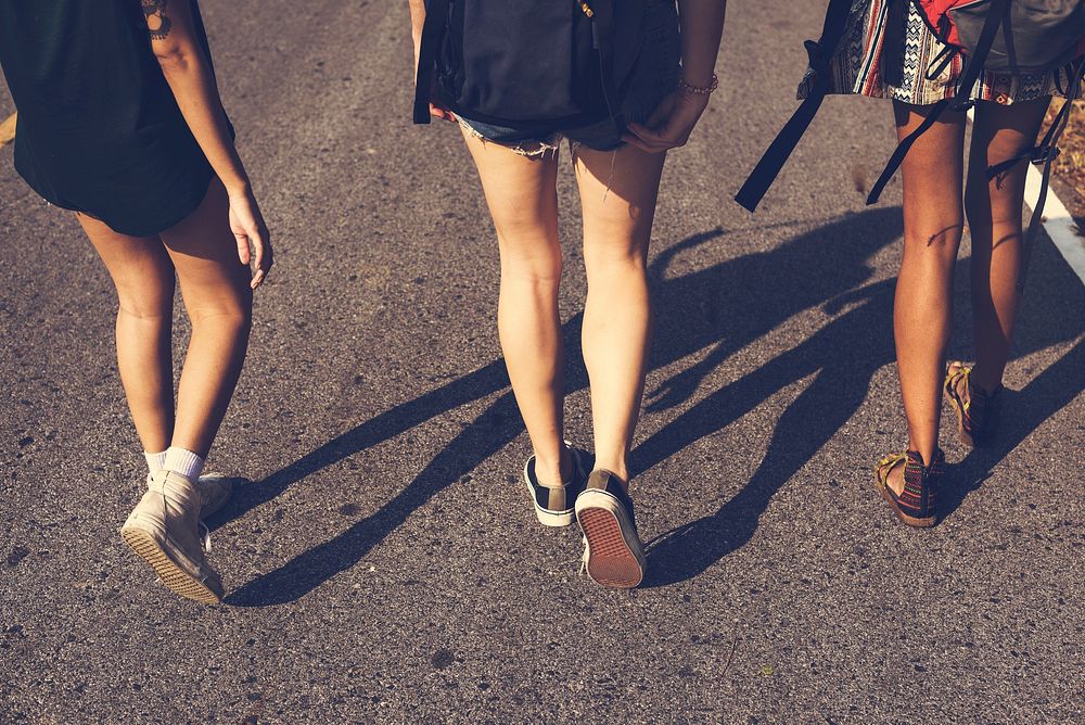 Group of Diverse Backpacker Women Walking along The Street Side