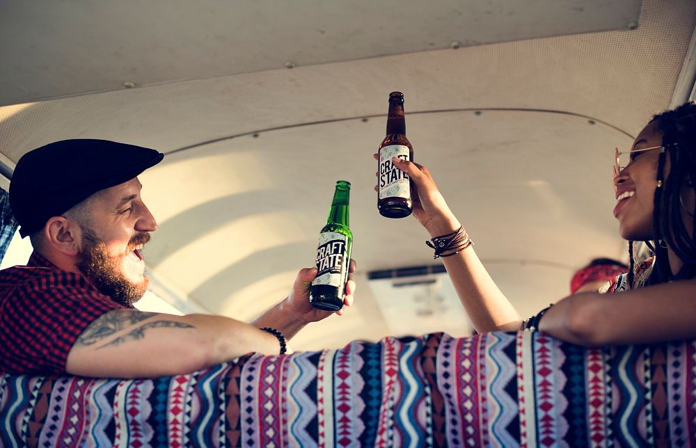 Friends Drinking Alcohol Beers Together on Road Trip Journey