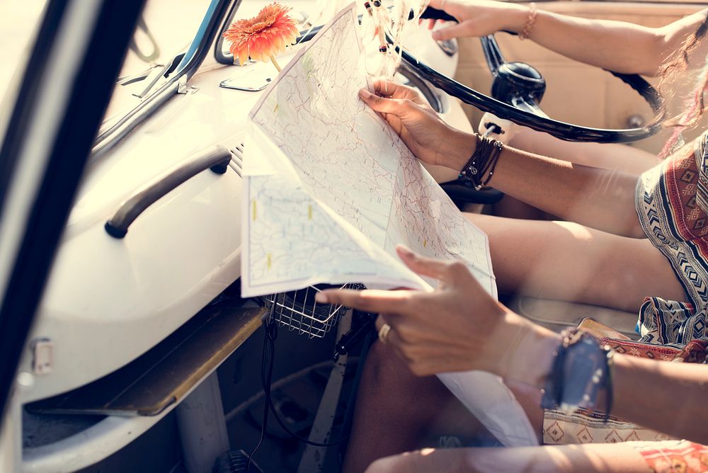 People Checking The Map for Direction on Road Trip