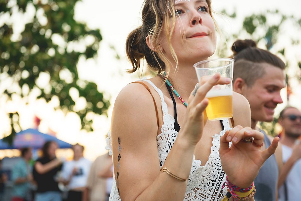 Woman with Beers Enjoying Music Festival