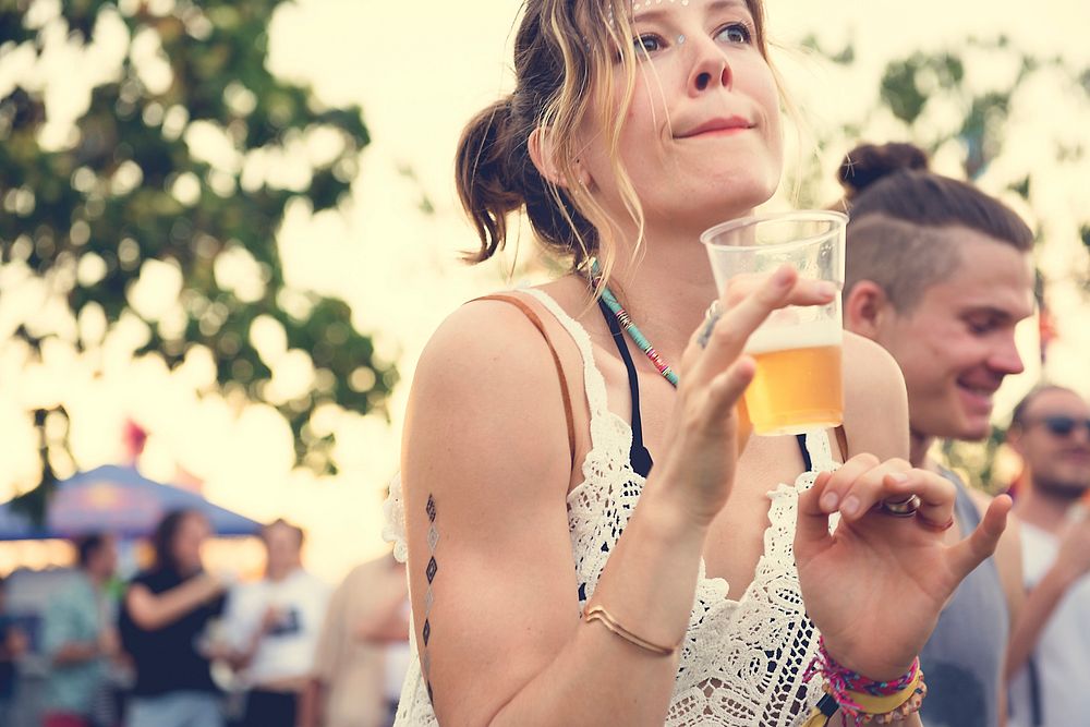 Woman with Beers Enjoying Music Festival